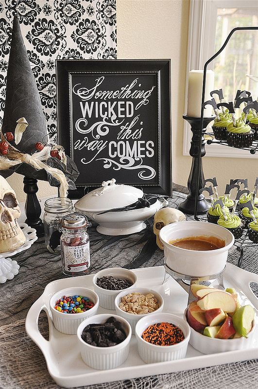 style the food bar with a sign, skulls, a witch hat and some witch shoes toppers on the cupcakes