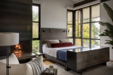 09 The bedroom features dark wood and metal, a hearth and amazing views