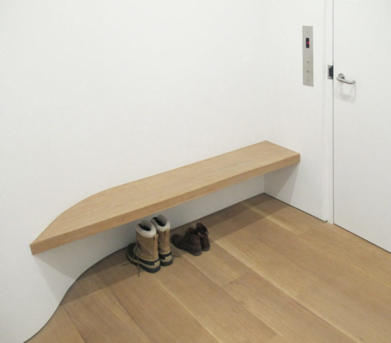 The entryway features just a buiilt-in bench and curves to make the space more interesting