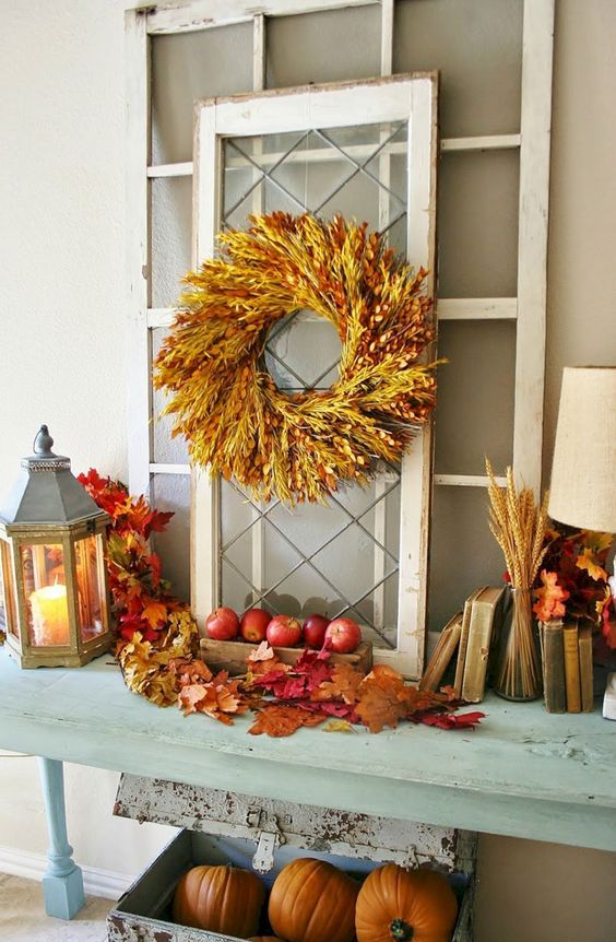 All natural and rustic fall decor done with fall leaves, wheat, a wheat wreath, apples and pumpkins is just amazing