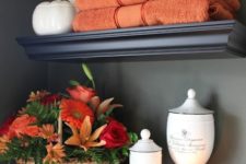 11 orange towels and a bright fall bloom arrangement in a basket will make your bathroom feel like fall