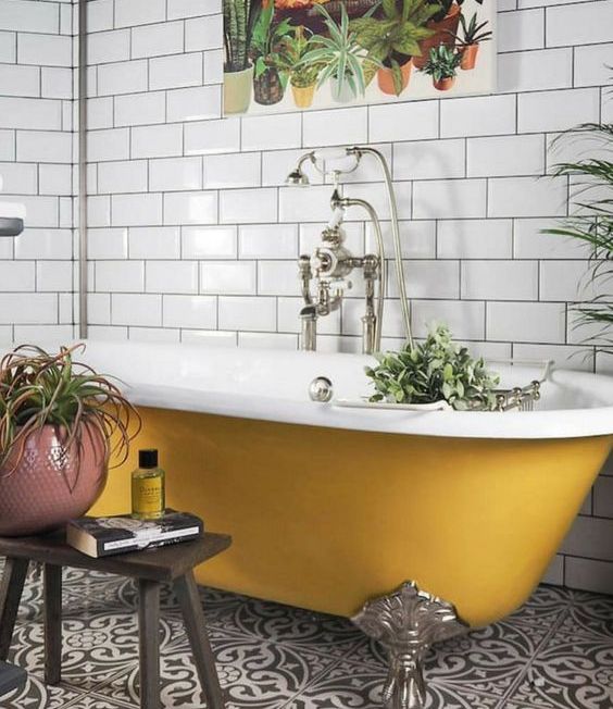 a yellow clawfoot bathtub is a cool colorful accent in fall style, it's a great idea for embracing the season