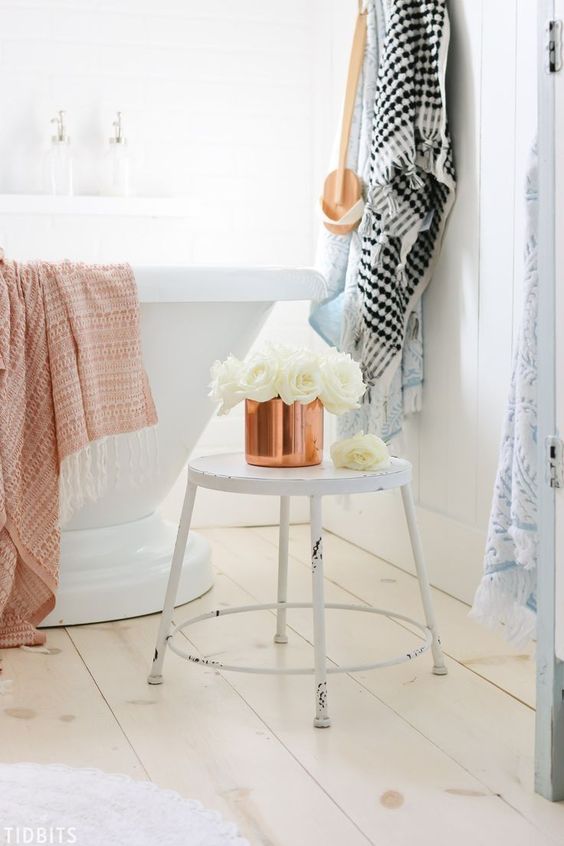 a copper pot with white roses and a copper towel are easy details to bring a fall feel to the space