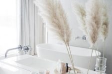 15 a dried grass arrangement in a clear vase is a cool fall accent for a contemporary or minimalist bathroom