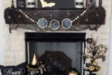 18 a stylish black and gold Halloween mantel with bats, candles, vases with branches, skulls and lots of painted pumpkins is wow