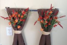 21 an easy and pretty bathroom decoration with brown towels and bright fall blooms attached to them