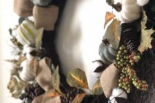 24 a fall wreath of faux details – pumpkins, gourds, berries, pinecones and cotton, which is dry, will last for long