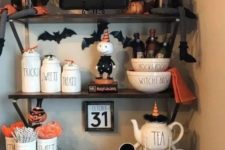 25 style your hot cocoa bar with black and orange mugs, bats, pumpkin figurines and signs to make it Halloween-like
