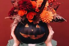 a stylish black halloween pumpkin with flowers
