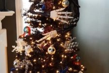a black Halloween tree decorated with lights, skulls, snowflakes and Jack Skellington embracing it