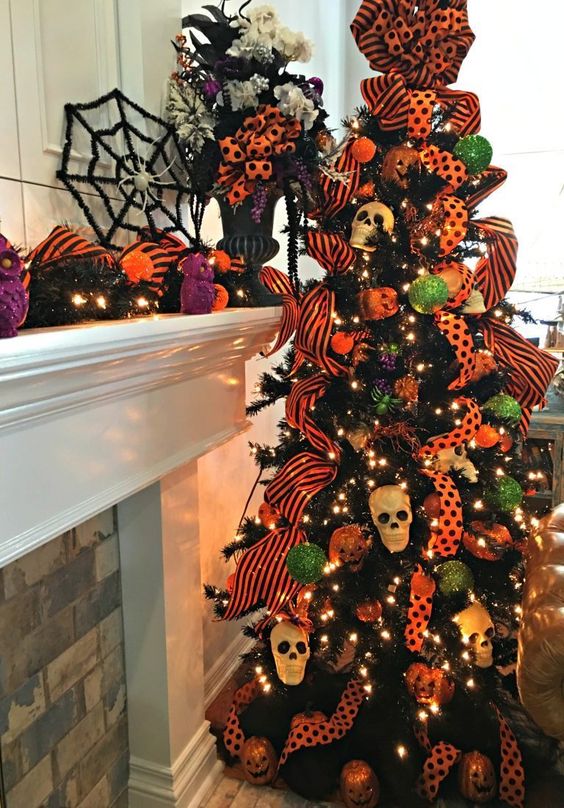 a black Halloween tree with lights, bright orange ribbons, mini skulls and green and orange ornaments