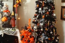 a black Halloween tree with lights, spiders, orange and black ornaments, a witch hat on top and some garlands and banners