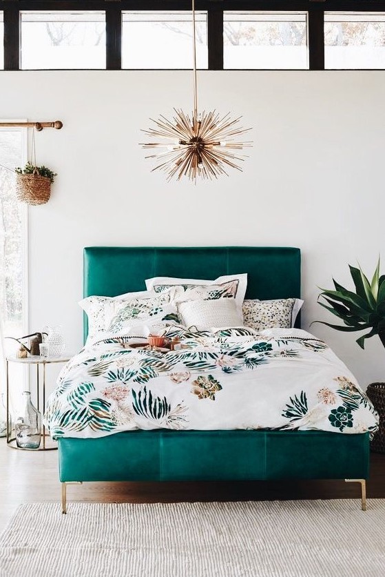 A bold teal leather mid century modern bed with gold legs is a bright touch to your space