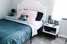 a glam Halloween bedroom with pretty photos, a coffin silhouette, a coffin and a skeleton rug and black and pink pillows