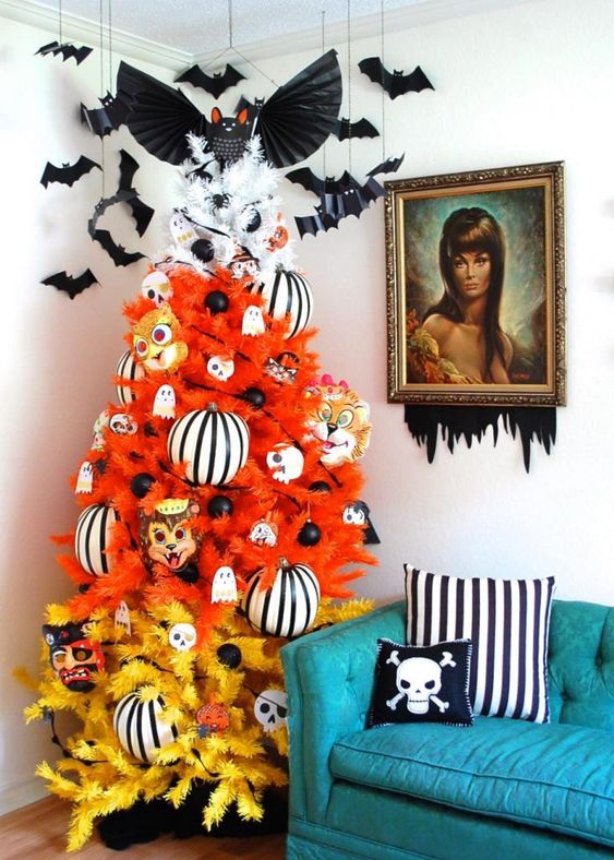 a gradient orange, yellow and white Halloween tree decorated with ghosts, striped ornaments, masks and bats