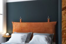 a hanging headboard of amber leather looks soft and textural and adds interest to the space