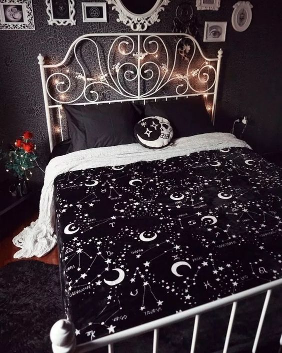 a moody bedroom spruce up with lights, celestial bedding, a skull moon pillow and some red roses for Halloween
