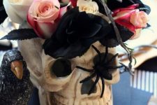 a skull with white, black and pink roses and a spider is a cool and quick to make Halloween centerpiece