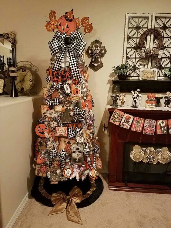 a vintage-inspired Halloween tree decorated with checked bows, cardboard pumpkins, watches, letters and garlands