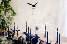faux blackbirds, black candles in candleholders, some black spiderweb and hay for Halloween decor