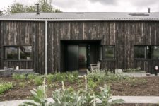 01 This home used to be a usual tractor shed, which was renovated and turned into a home, it was clad with scorched wood and resembles a barn