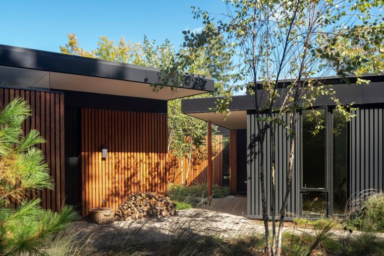 The house is clad with natural local wood in slabs to give it a contemporary and fresh look