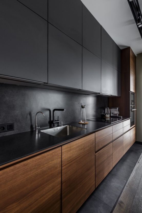 a minimalist black kitchen with sleek wooden lower cabinets that are a stylish option to spruce up the space