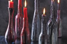 02 black bottles with red and deep purple wax from candles on them look scary and bloody, so you won’t have to decorate the holders too much