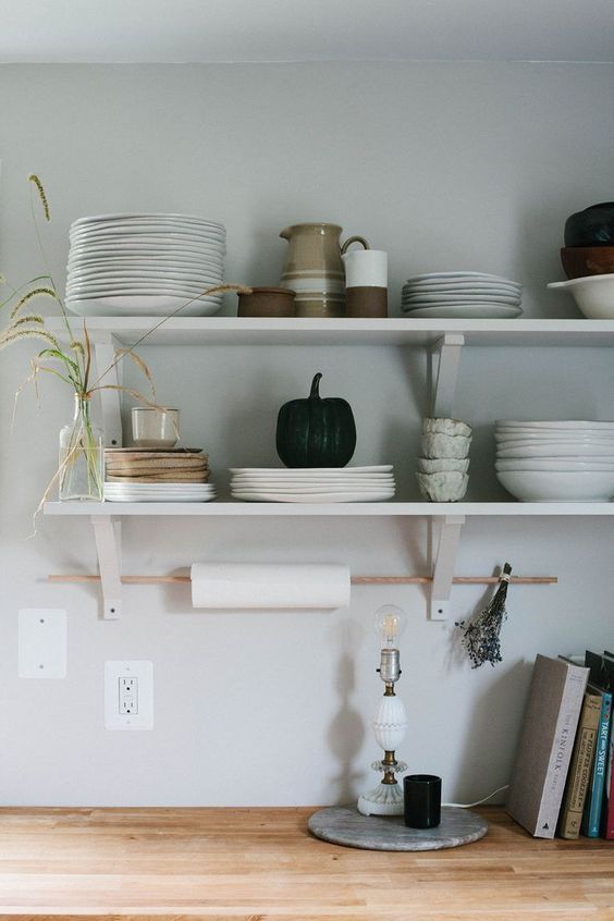 open minimalist shelves in the kitchen and a stick for hanging kitchen towels are a serene and cool kitchen