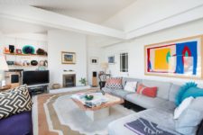 02 this basically neutral living room was spruced up with bright artworks, rugs, pillows for a bold and chic look