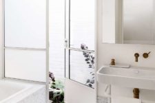 03 The bathroom is done with white terrazzo, with an inner courtyard that allows to connect the space to outdoors