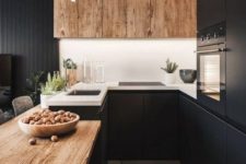04 a black kitchen refresh with a white backsplash and wooden uppers plus a wooden countertop for a cozier feel