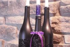 04 bottles painted matte black and blakc glitter with a purple bow and matching candles for Halloween candleholders