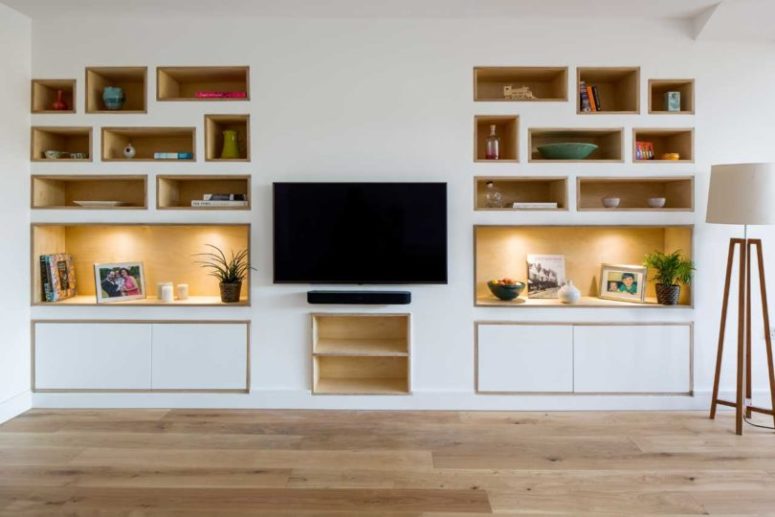 The living room is done with built-in shelves and a wall-mounted TV