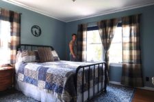 05 This is a blue guest bedroom with a forged bed, plaid curtains, blue textiles and vintage furniture