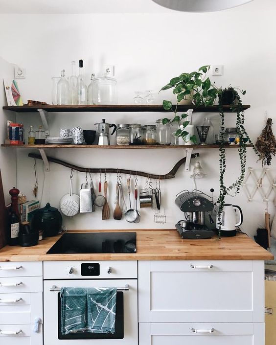 thin dark shelves of reclaimed wood is a nice natural touch to your kitchen and a branch adds even more