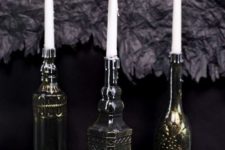 05 vintage bottles painted black and bronze to make the look like refined metal candleholders are chic and elegant