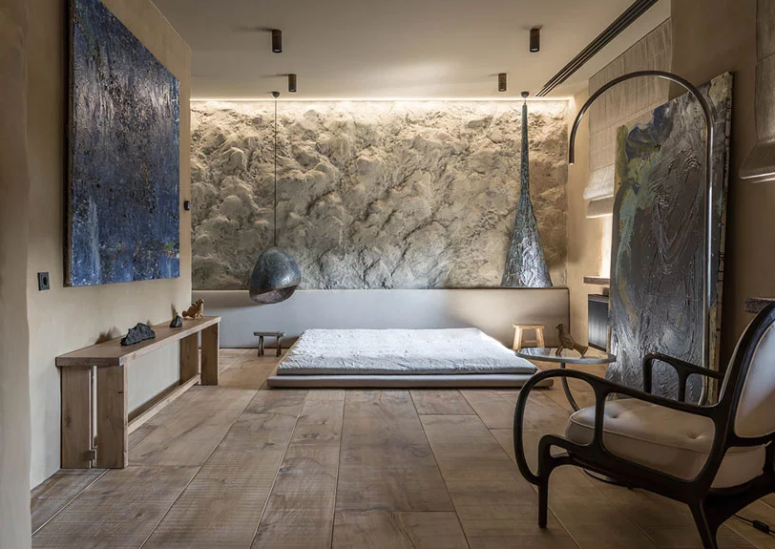 Another bedroom is full of art, there's a unique textural wall and creative pendant lamps