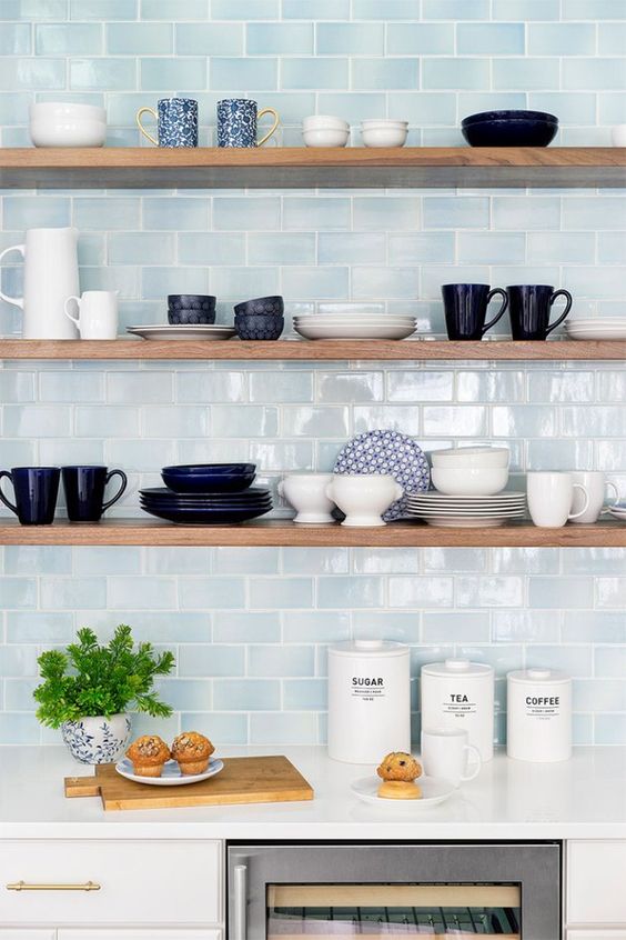 stylish minimalist shelves in front of a blue tile wall look outstanding and will make your objects displayed the best way possible