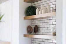 07 thick wooden shelves in a white tile niche look warming up and give a slight farmhouse feel to the space