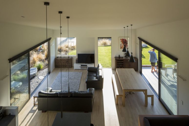 The dining zone and living room are united into one space, which is opened and well-lit