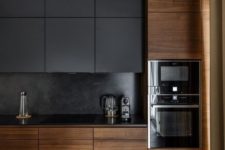 08 a dark black kitchen with sleek wooden cabinets that make it cozier and more welcoming