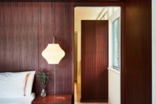 09 The bedroom is fully clad with mahogany, there are elegant lamps and a comfortable bed