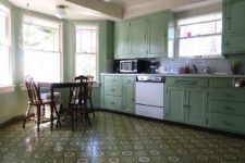 09 The kitchen is done in green, with vintage cabinets that originate from 1930s