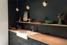 09 a minimalist black kitchen spruced up with a white sink and a wooden shelf plus countertops for a fresh look