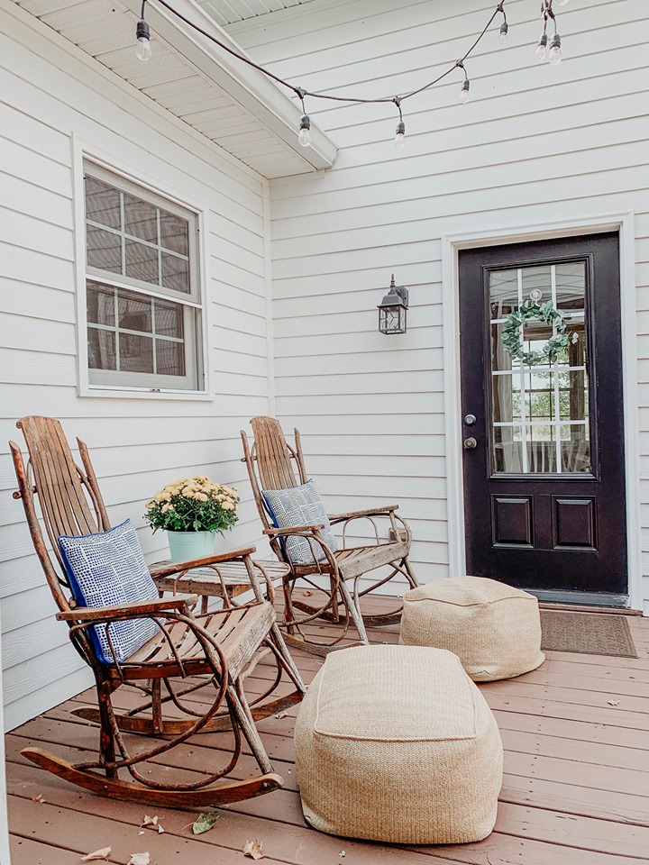 There's another porch done with burlap ottomans and wicker and wooden rockers