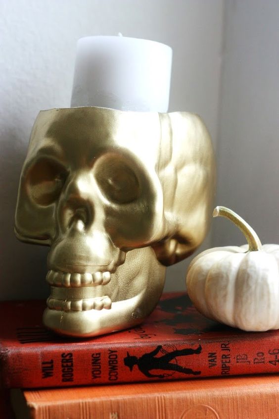 a gold skull candleholder can be eaisly DIYed and used anytime for Halloween decor, it will match most of themes