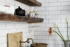 11 dark reclaimed wooden shelves look very bold and standing out in front of a white tile wall