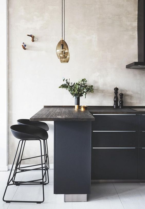 a black kitchen refreshed with neutral plaster walls and a white tile floor has a totally different look than a solid blakc one