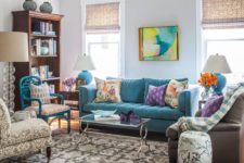 12 a super bright living room done with colorful furniture, artworks, blooms and accessories for a whimsy feel